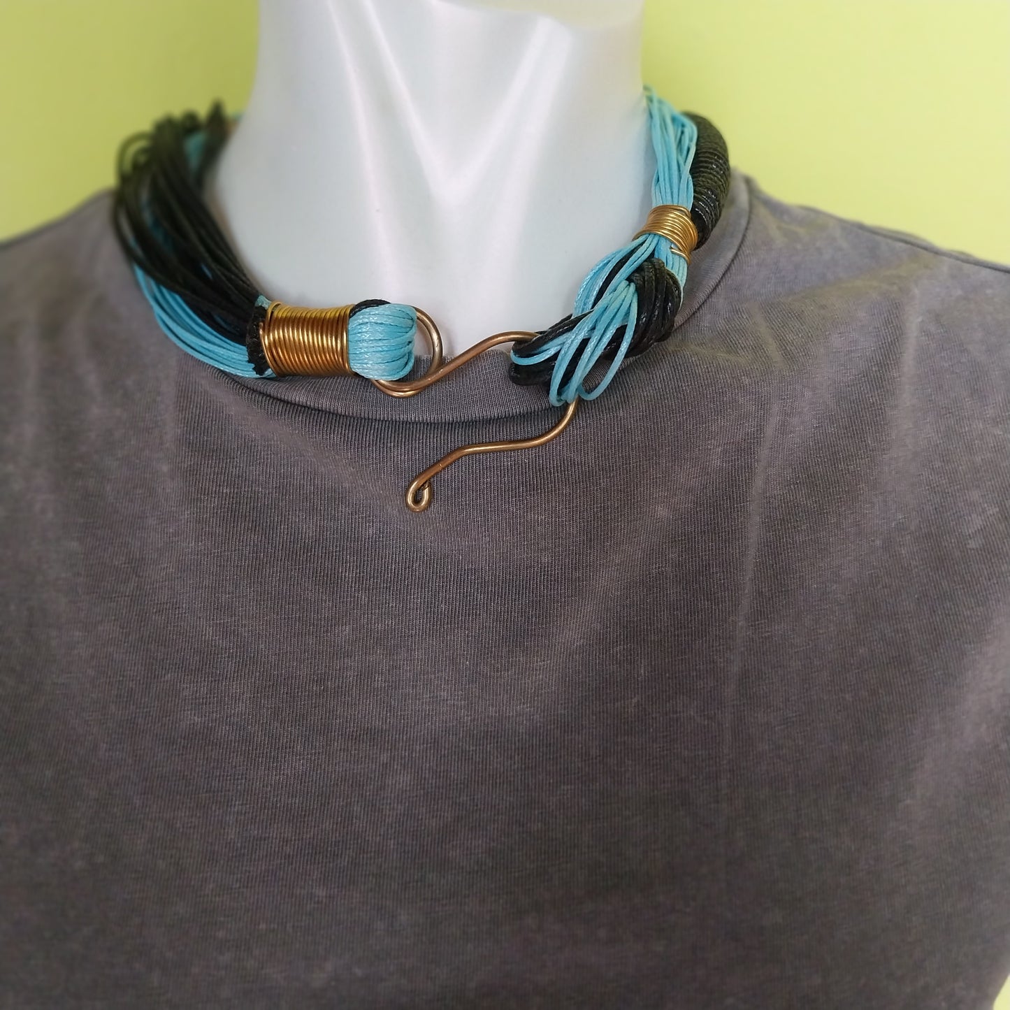 Handmade necklace with turquoise black cord and brass closure