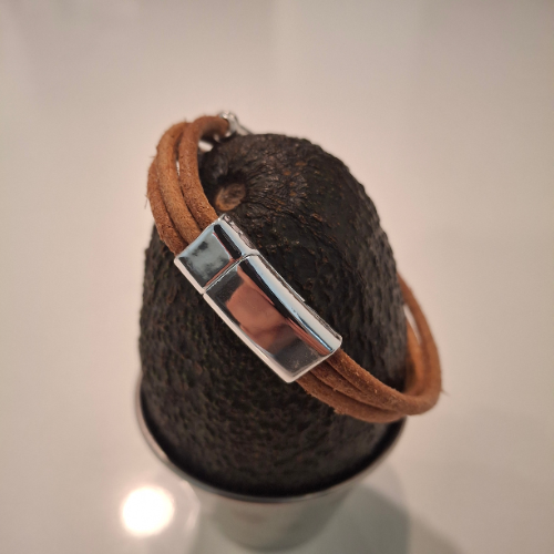 Close-up of Sasha Bracelet chrome accents on raw leather