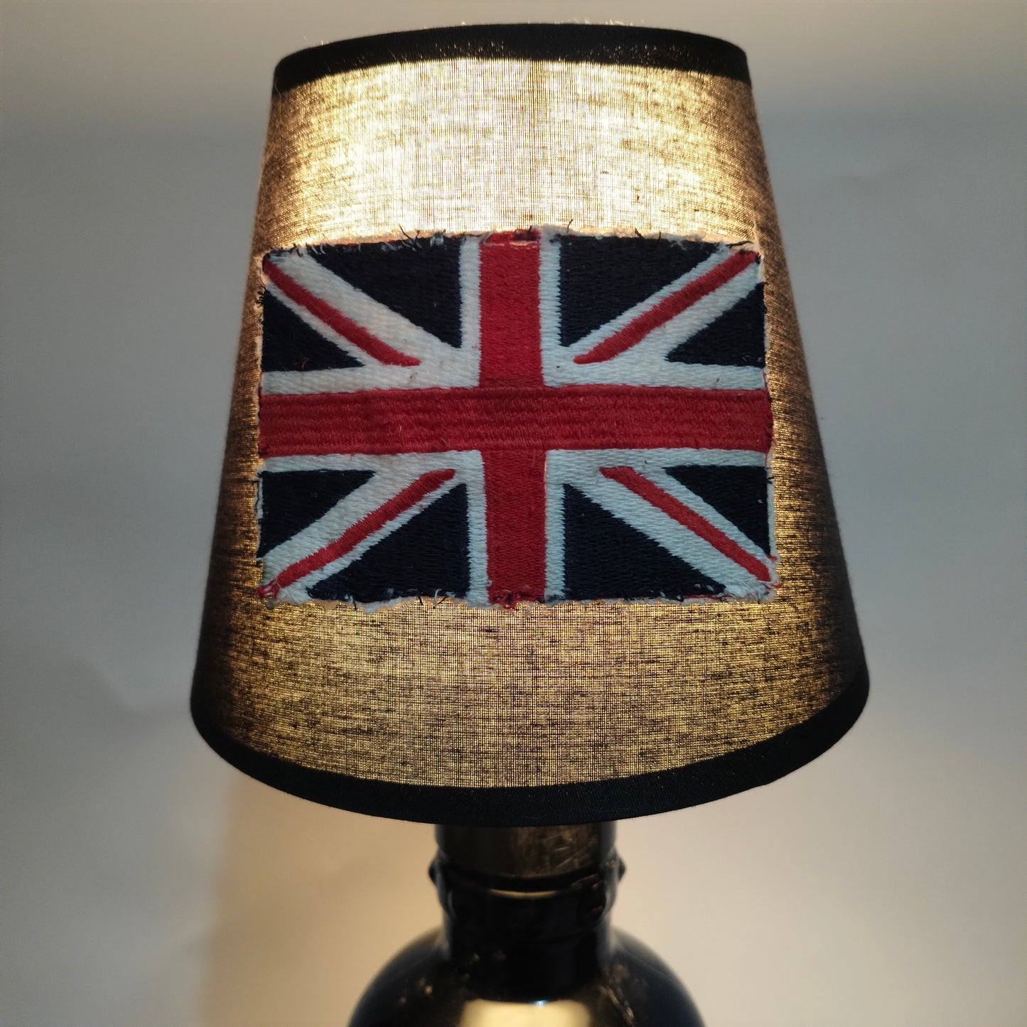Close-up of Bulldog Gin bottle base with black braided power cable and plug