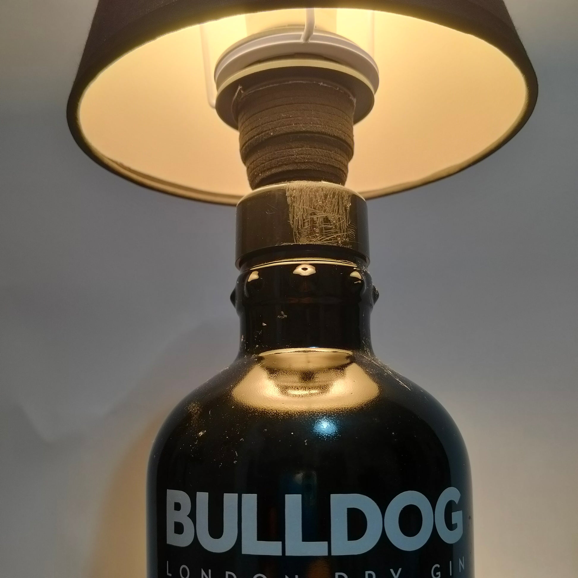 Handmade upcycled lamp showing Bulldog bottle neck and shade attachment