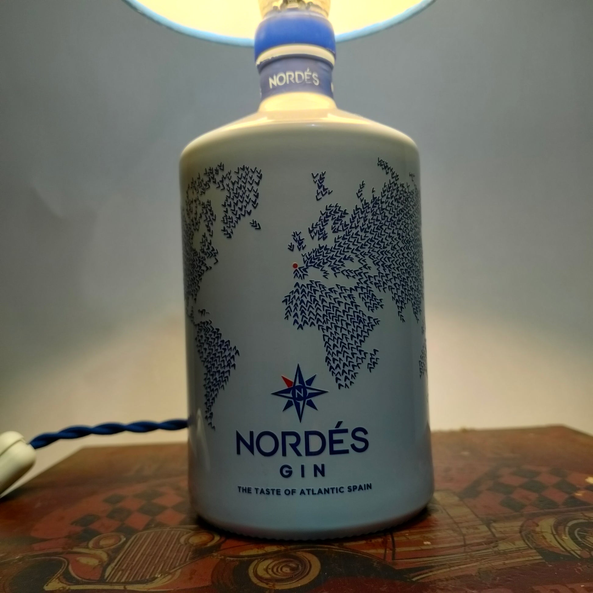 Detail of Nordés Gin bottle base with world map design